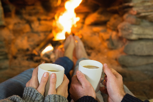 the couple in front of the camp fire