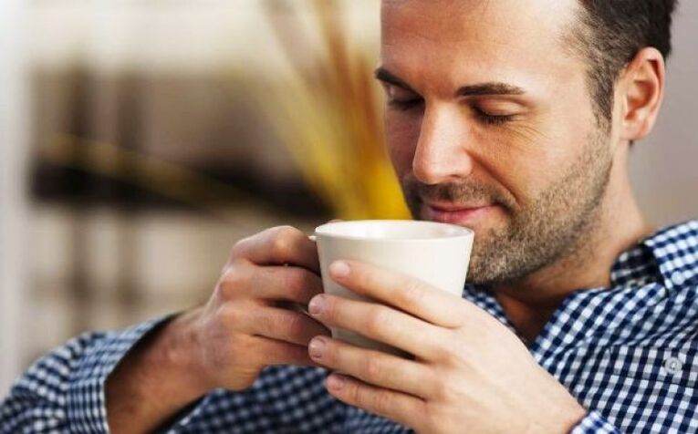 A man drinks a sip of fireweed tea to increase potency